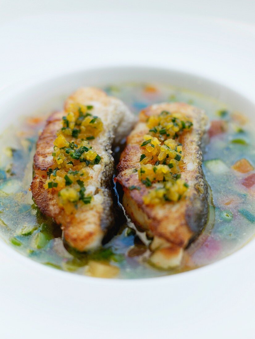 Grilled fish in vegetable broth