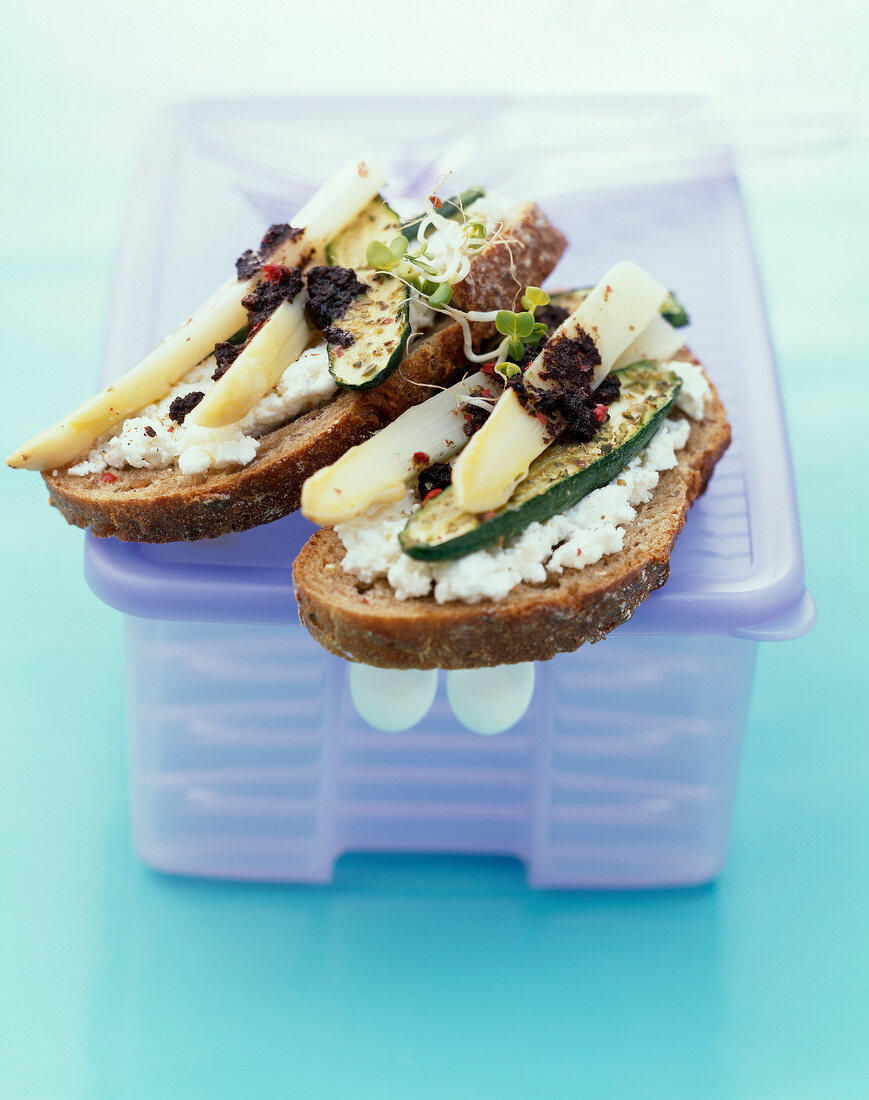 Cream cheese, zucchini, asparagus and tapenade open sandwich