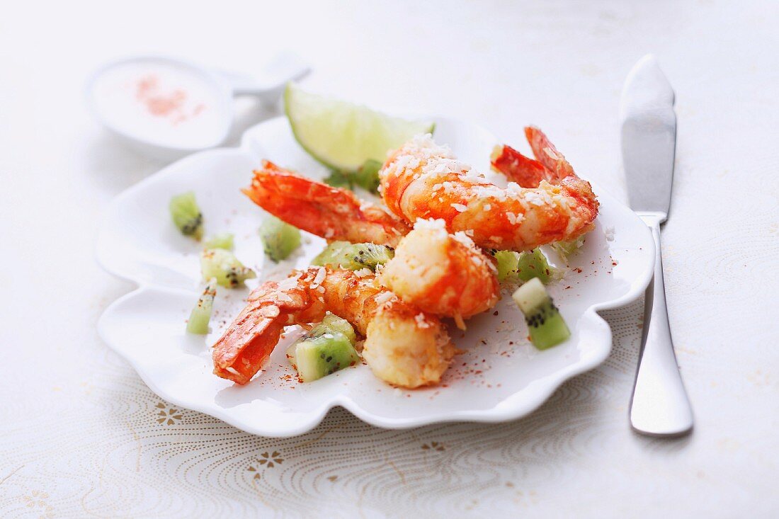 Gambas coated with grated coconut and diced kiwis