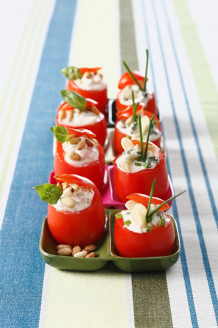 Small raw tomatoes stuffed with roquefort cream and almonds