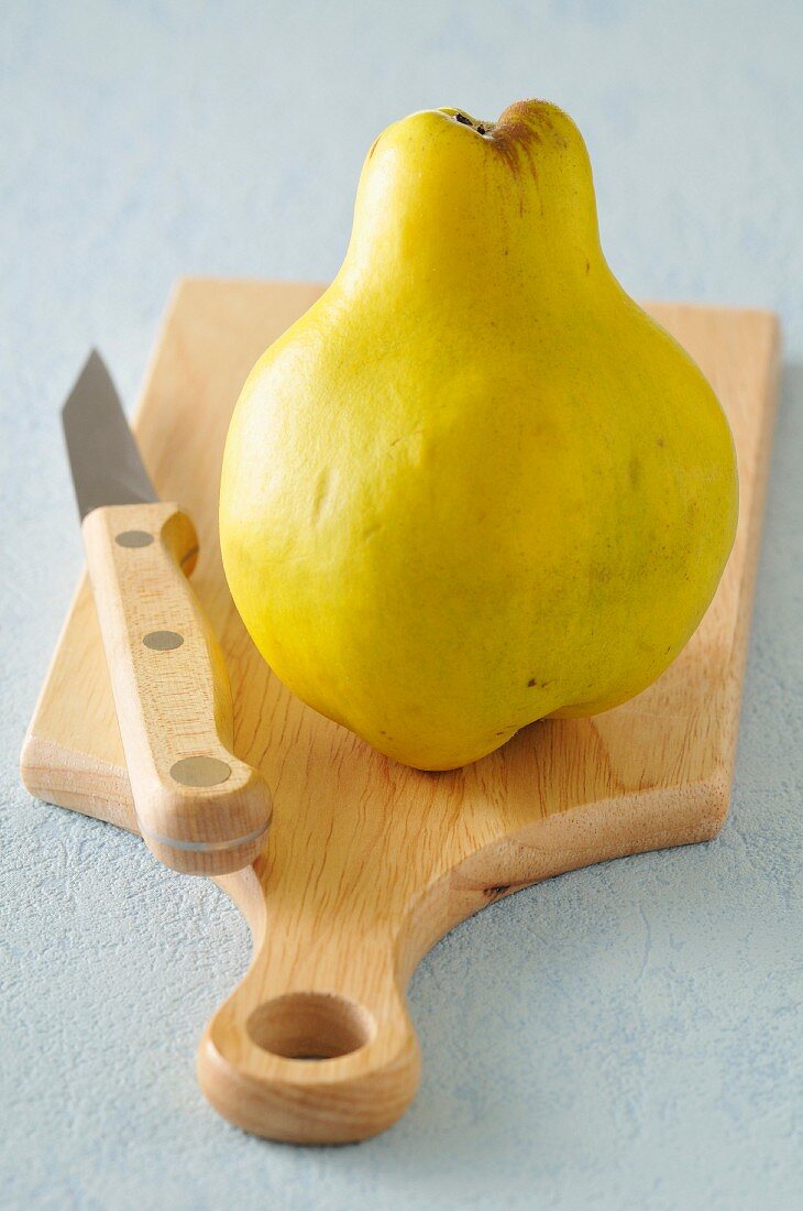 Whole quince on a cutting board
