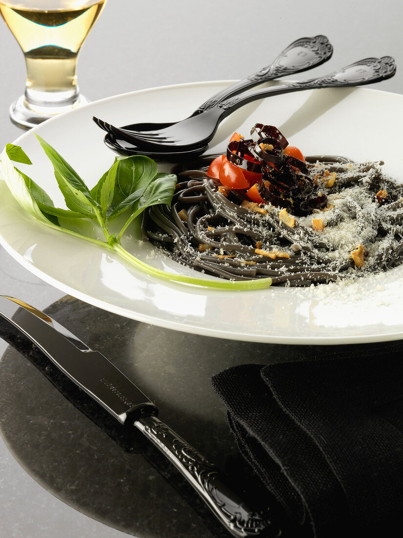 Squid ink spaghetti with purple peppers