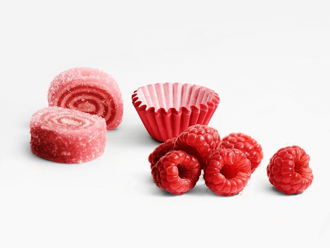 Raspberry rolled candies and paper cups
