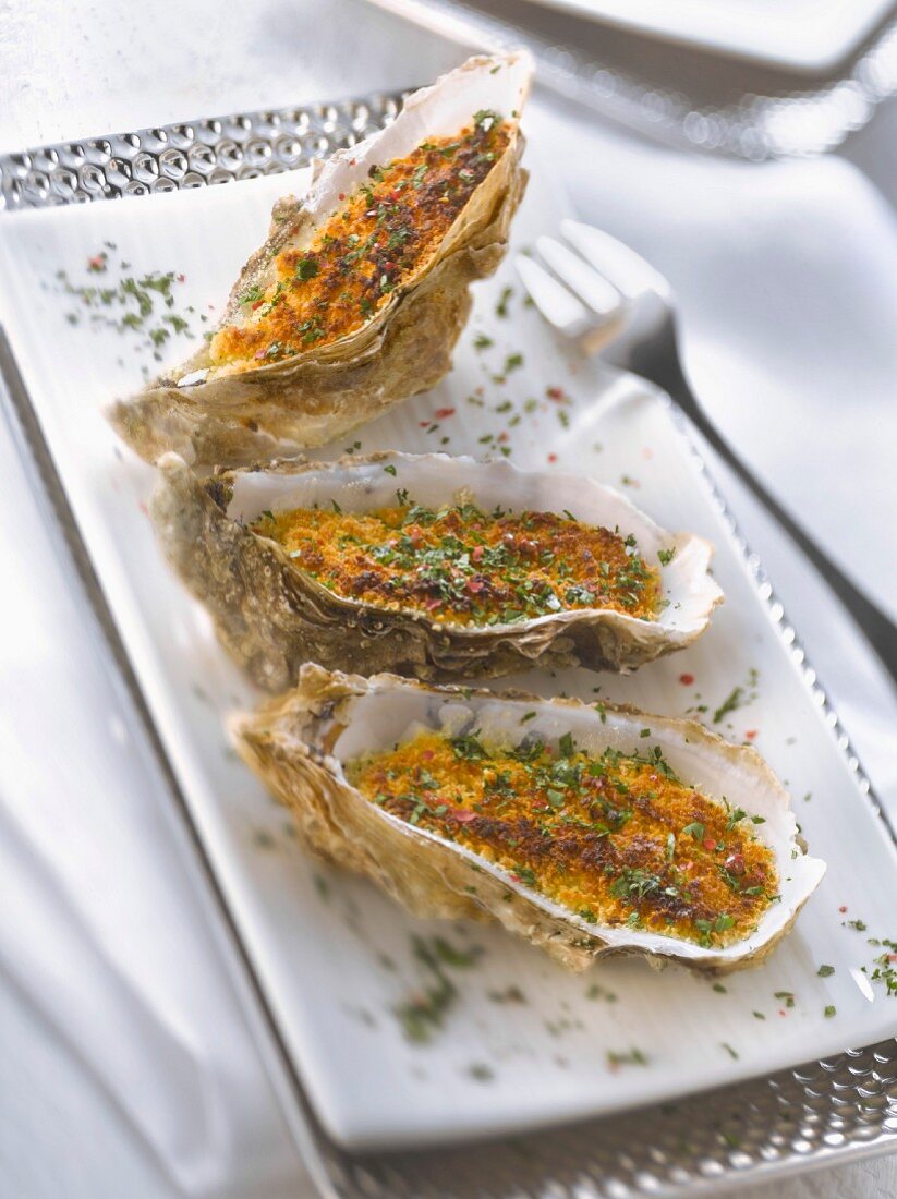 Grilled oysters with chopped parsley