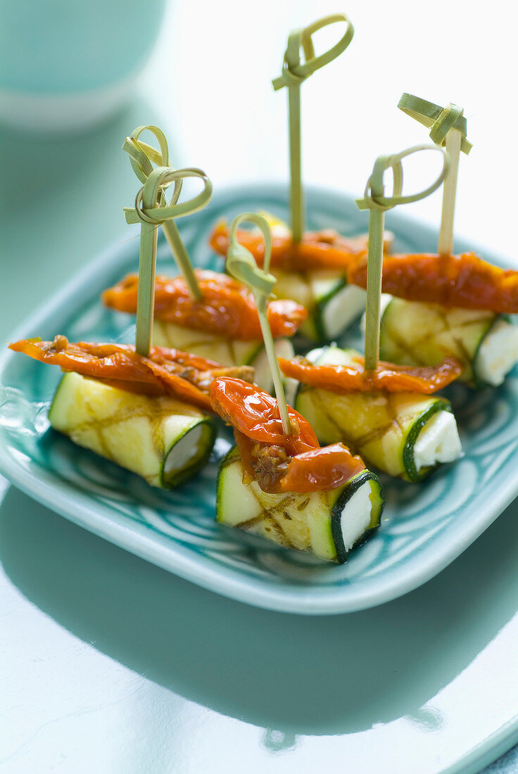 Grilled zucchini rolls stuffed with feta and sun-dried tomatoes