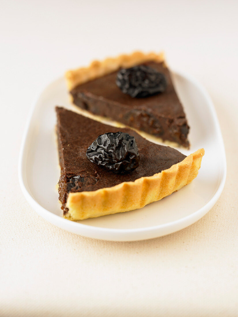 Portions of chocolate and prune tart