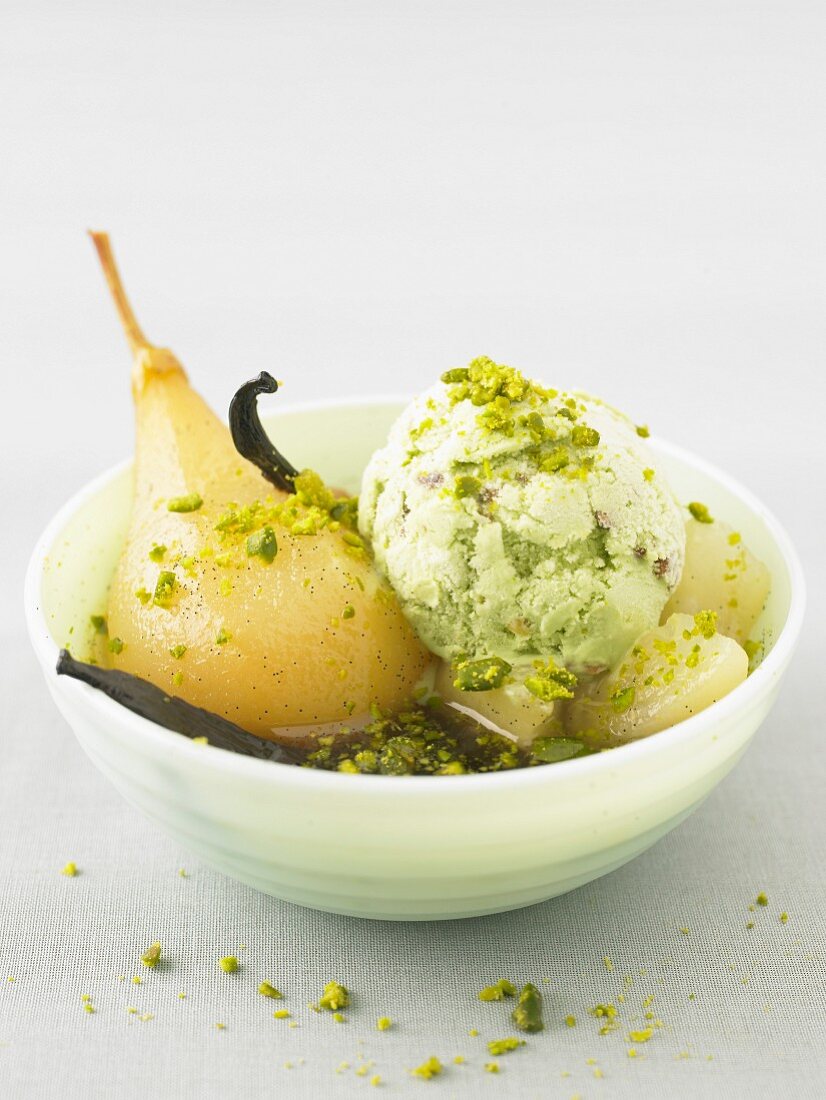 Poached pear in vanilla syrup with pistachio ice cream