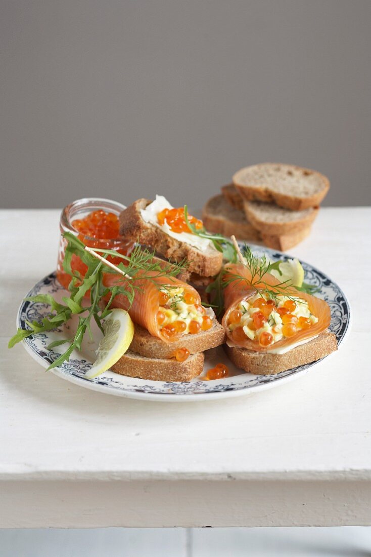 Smoked salmon rolls stuffed with scrambled eggs and fish roe