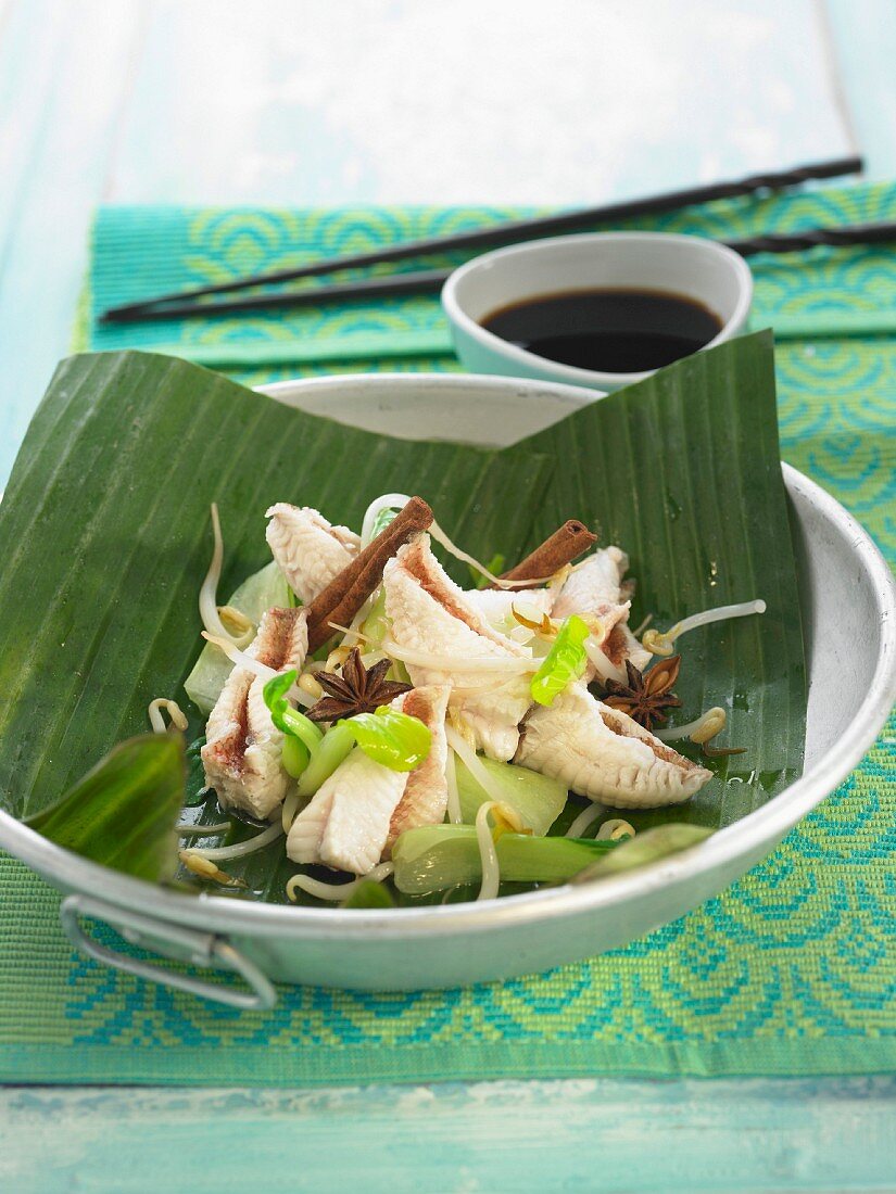 Red scorpion fish, beansprouts, pak-choy cabbage, cinnamon and star anise cooked in a banana leaf