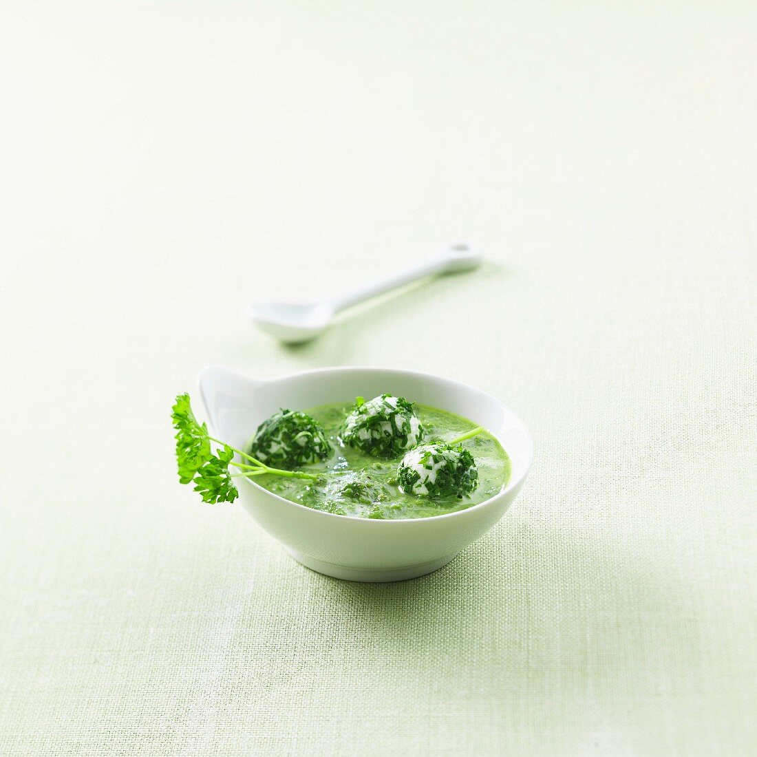 Herb soup with cream cheese and herb balls