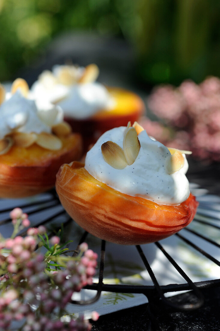 Grilled peaches with whipped cream and thinly sliced almonds