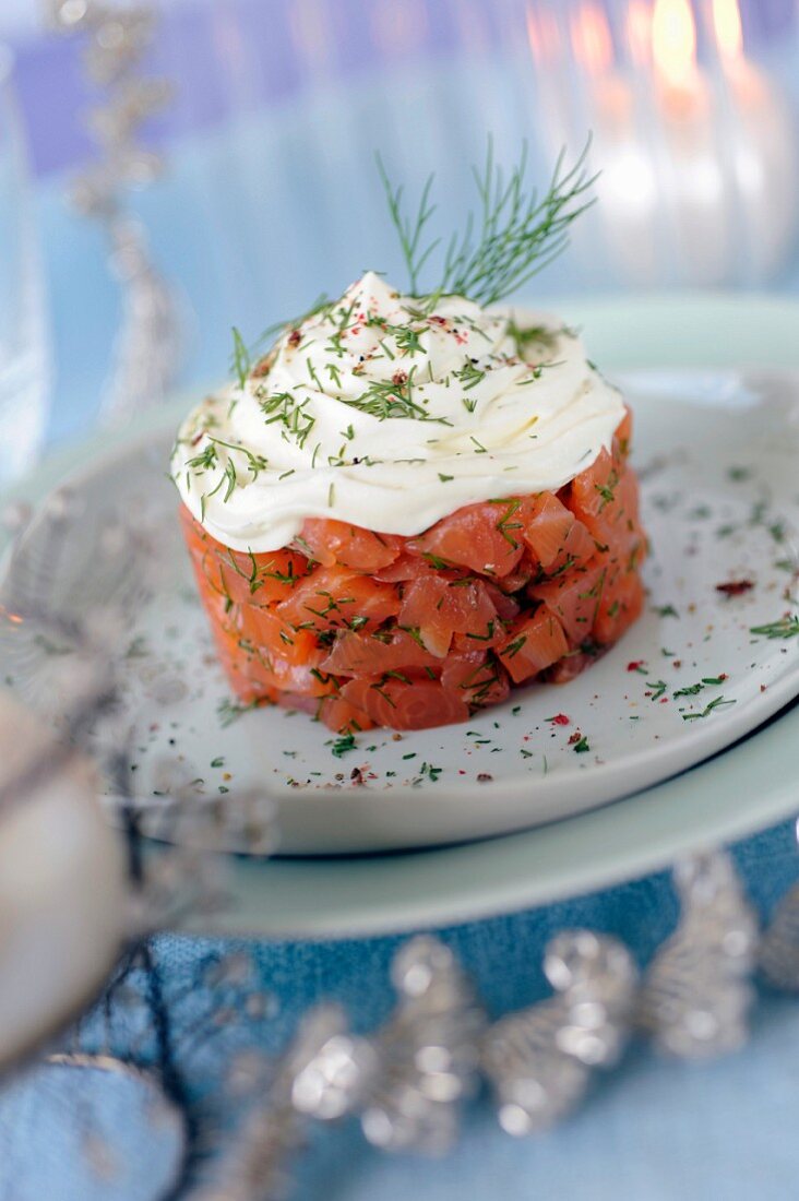 Gravlax-style marinated salmon topped with whipped cream and dill