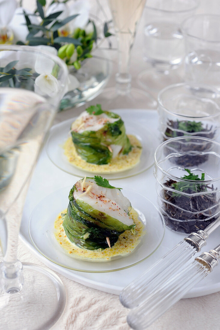 Piece of cod wrapped in sea lettuce,creamy seaweed sauce