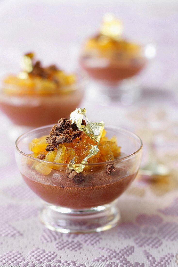 Chocolate mousse with stewed mangoes and golden flakes