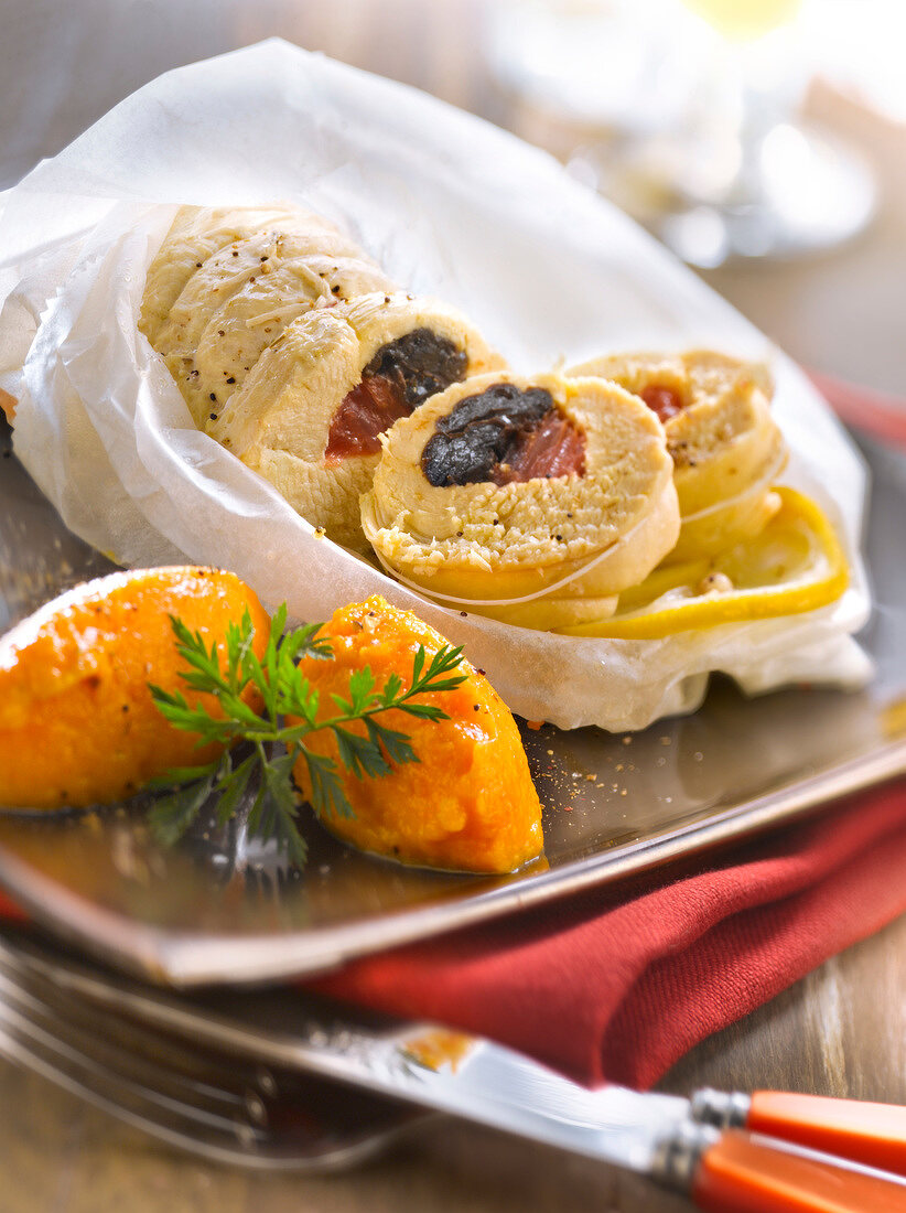 Chicken with citrus fruit and prunes cooked in wax paper,carrot puree