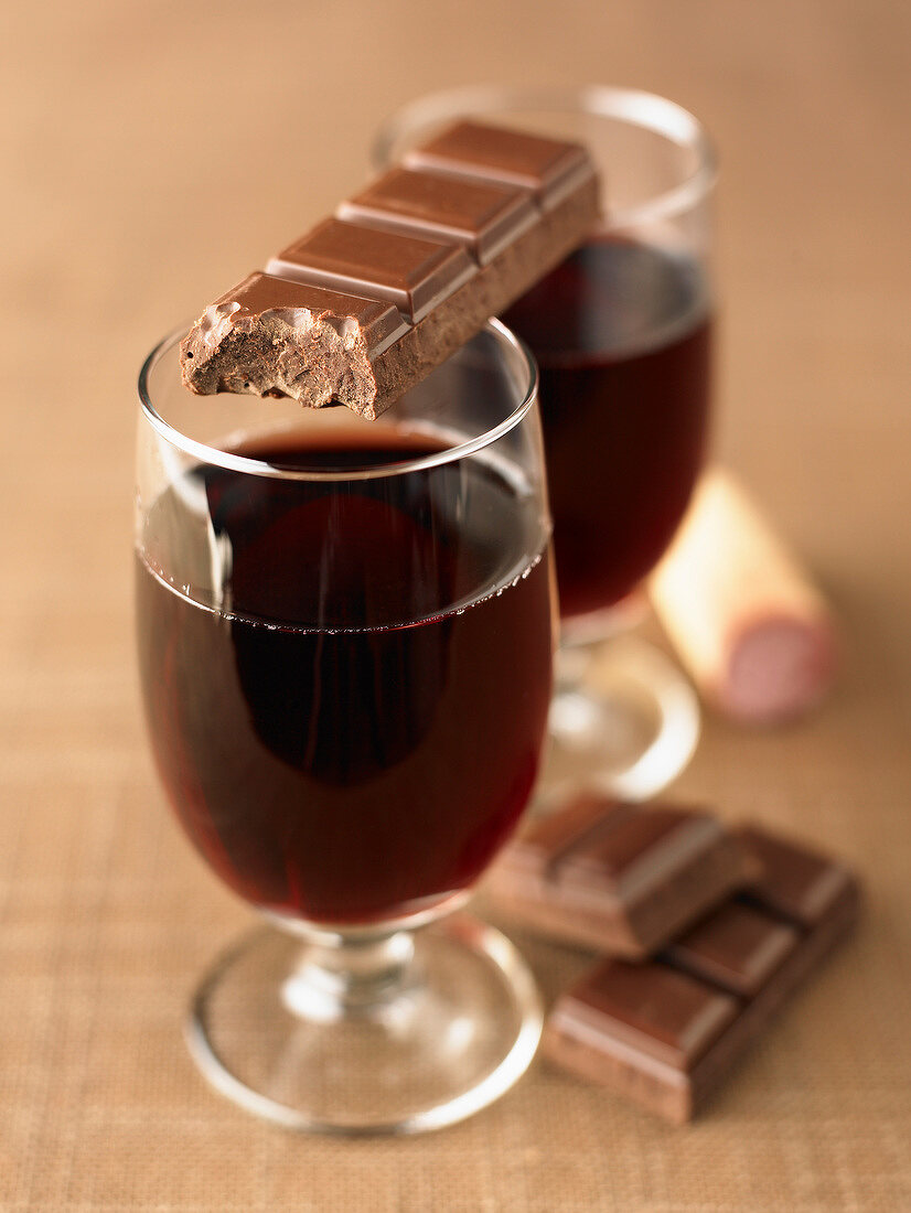 Glasses of red wine and squares of chocolate