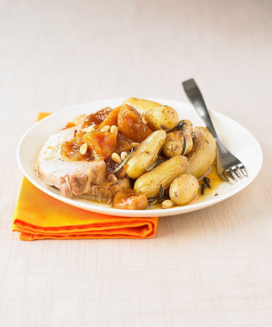 Roast pork with stewed fruit and potatoes with rosemary