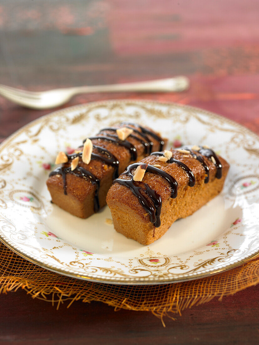 Mini almond cakes with melted chocolate topping