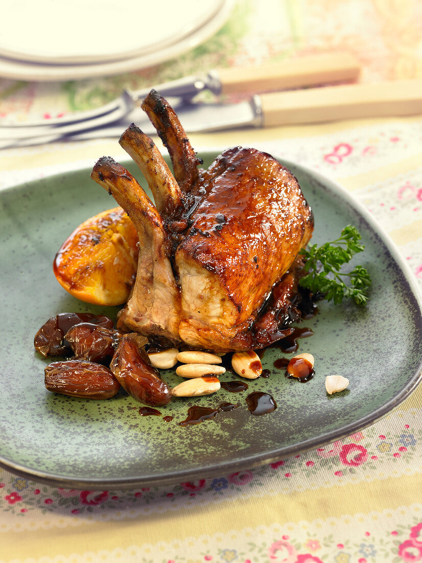 Caramelized loin of pork chops with dried fruit and orange