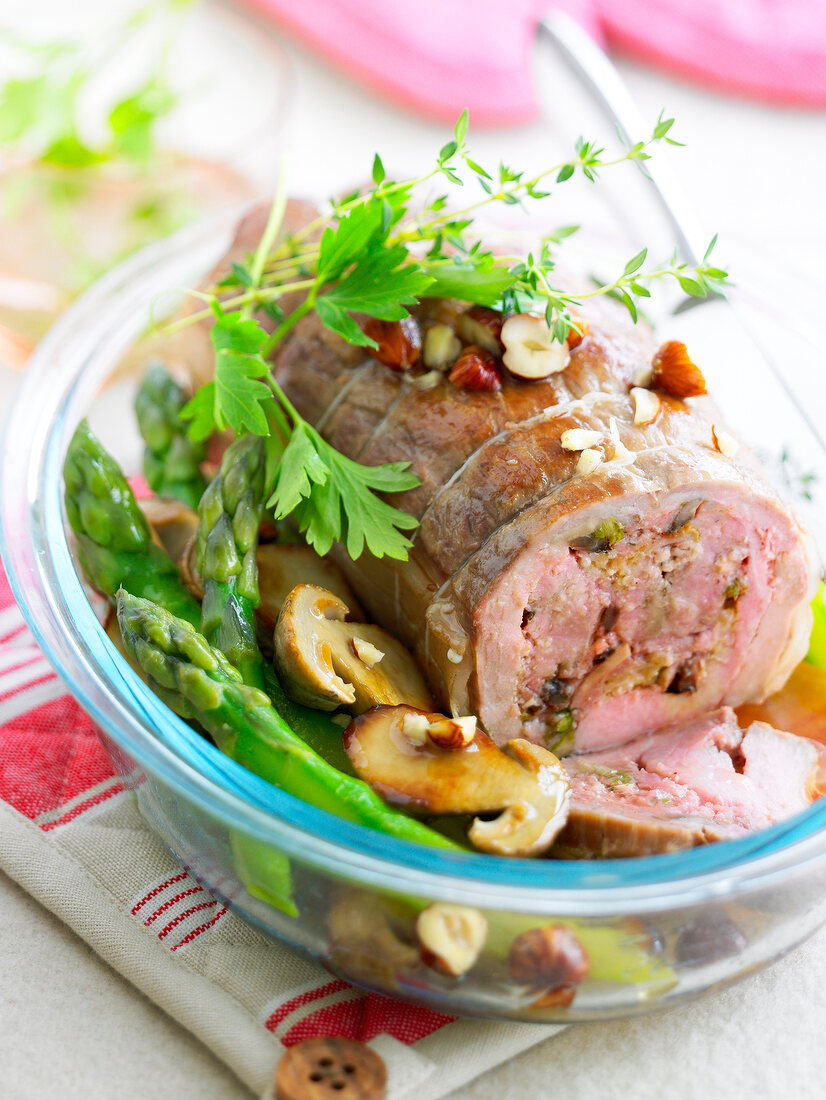 Stuffed roasted veal with green asparagus,ceps and hazelnuts