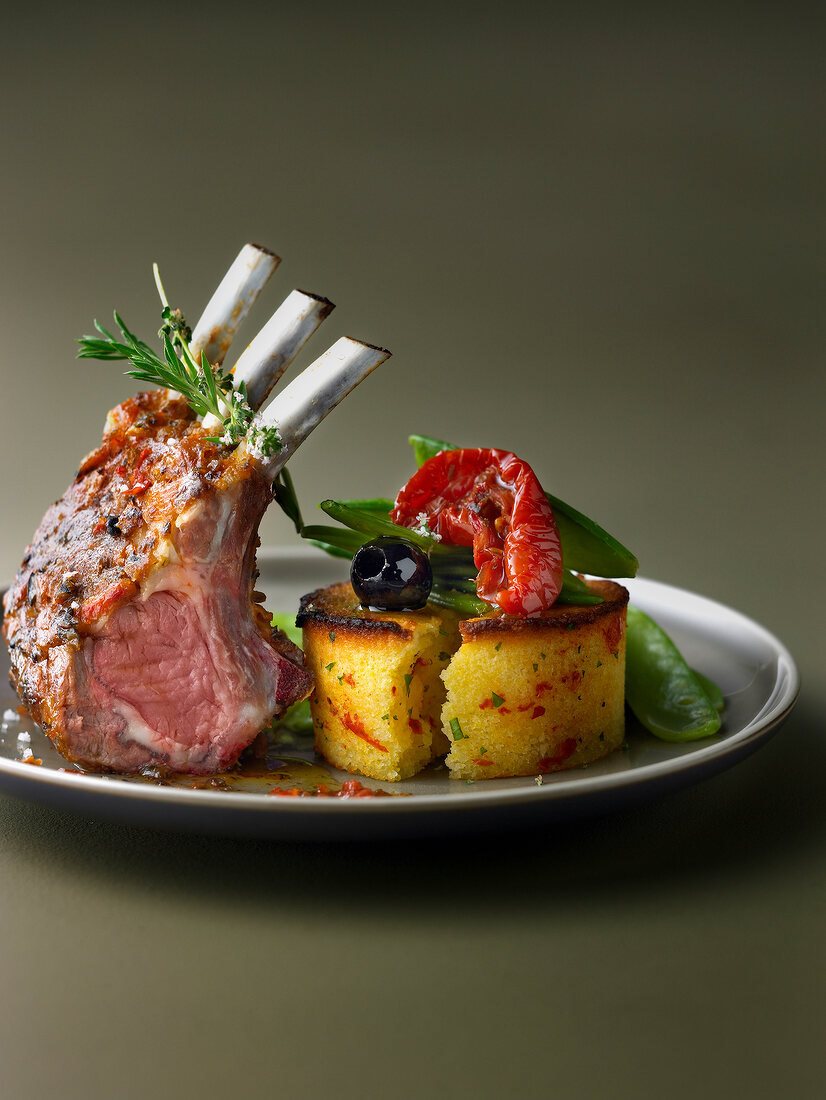 Loin of lamb with rosemary, polenta with cherry tomatoes and black olives