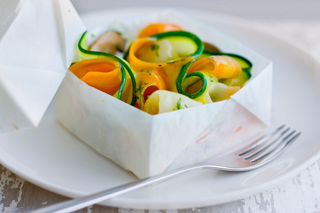 Thin strips of vegetables cooked in a square pack of wax paper