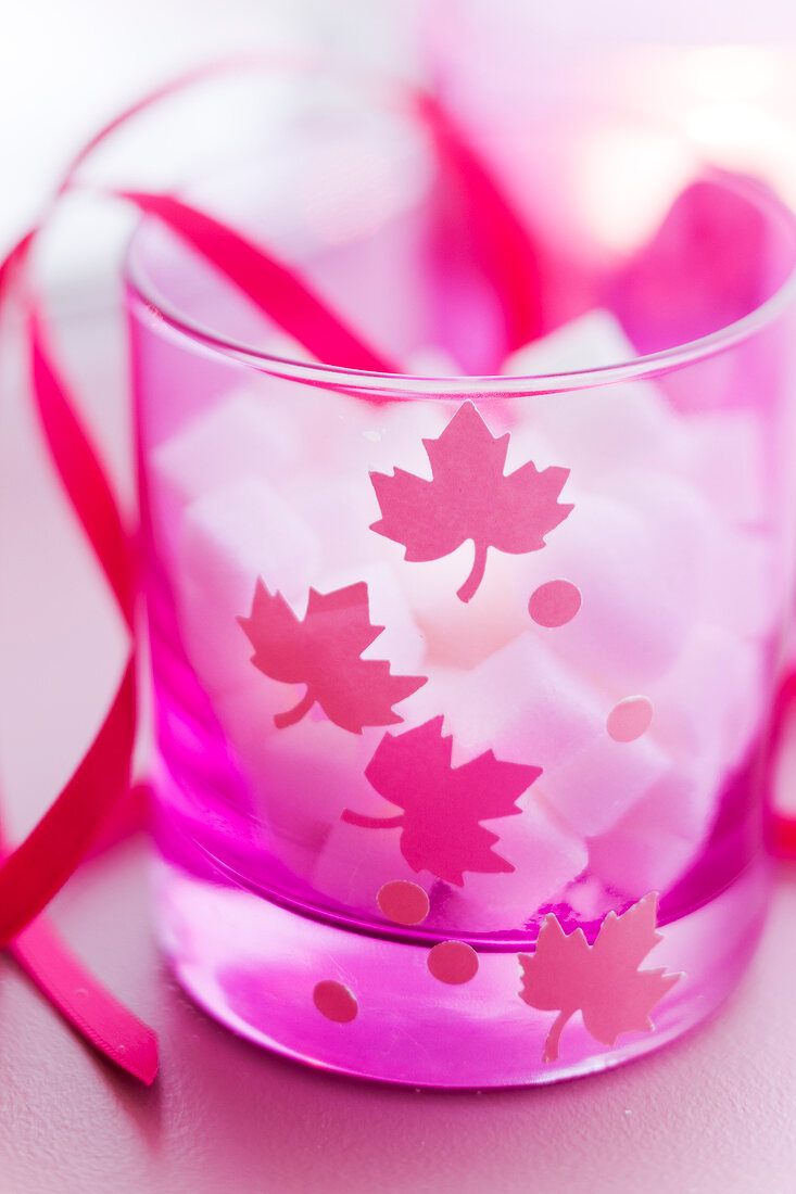 Sugar lumps in a decorated pink glass