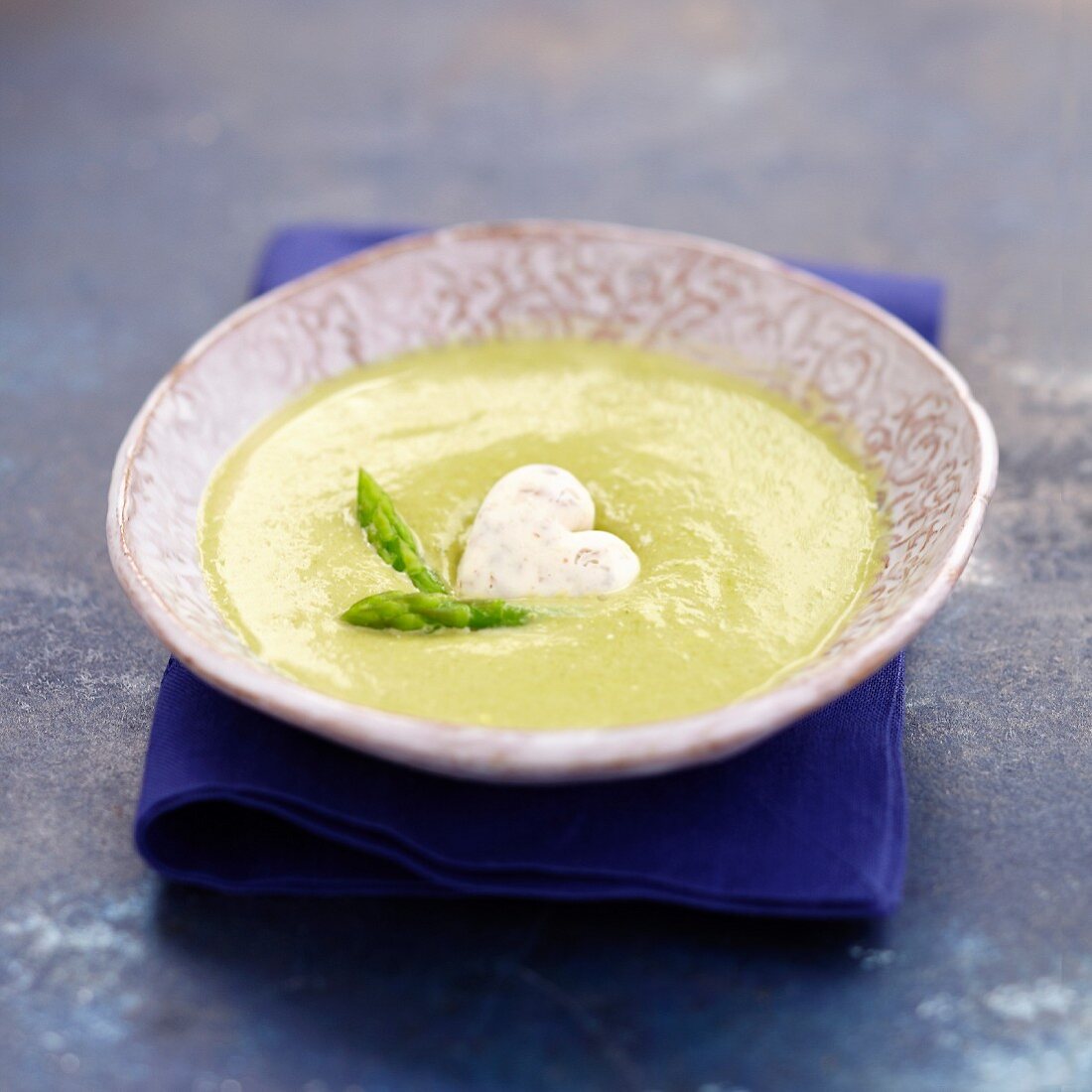 Cold cream of green asparagus soup with an almond-ginger ice cube