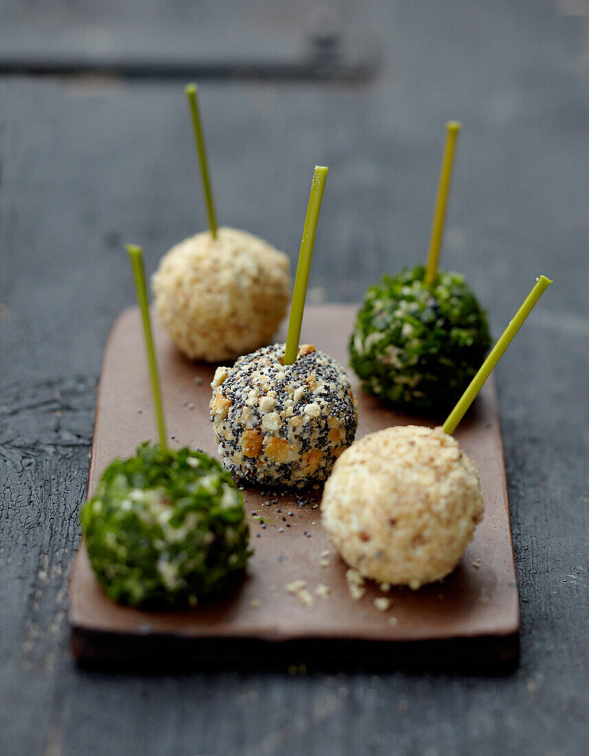 Three-flavored goat's cheese bites on sticks