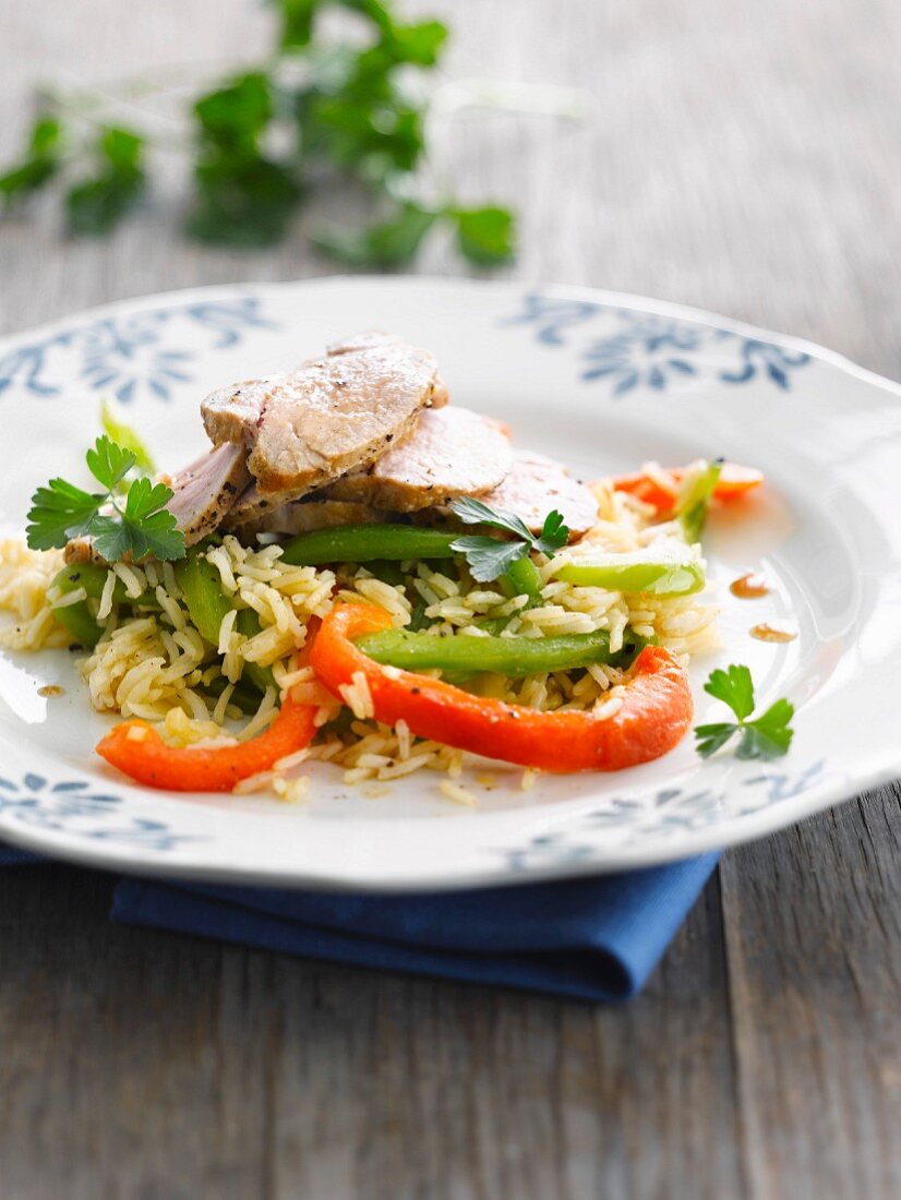 Thinly sliced pork ,basmati rice salad with red and green peppers