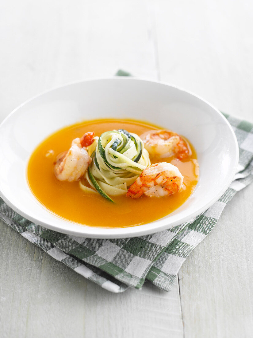 Pumpkin soup with shrimps, tagliatelles and zucchinis