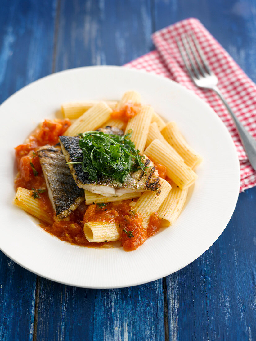 Rigatoni in tomato sauce with grilled bass