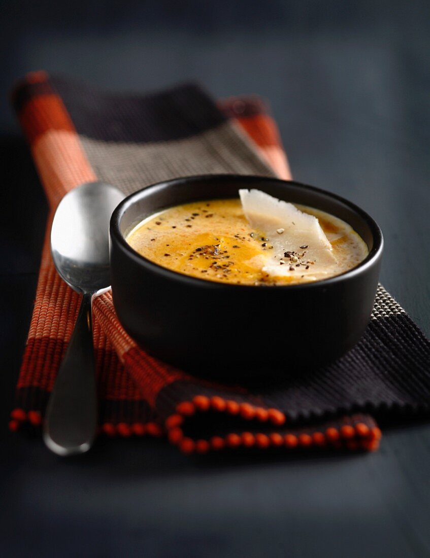 Cream of pumpkin soup with parmesan flakes