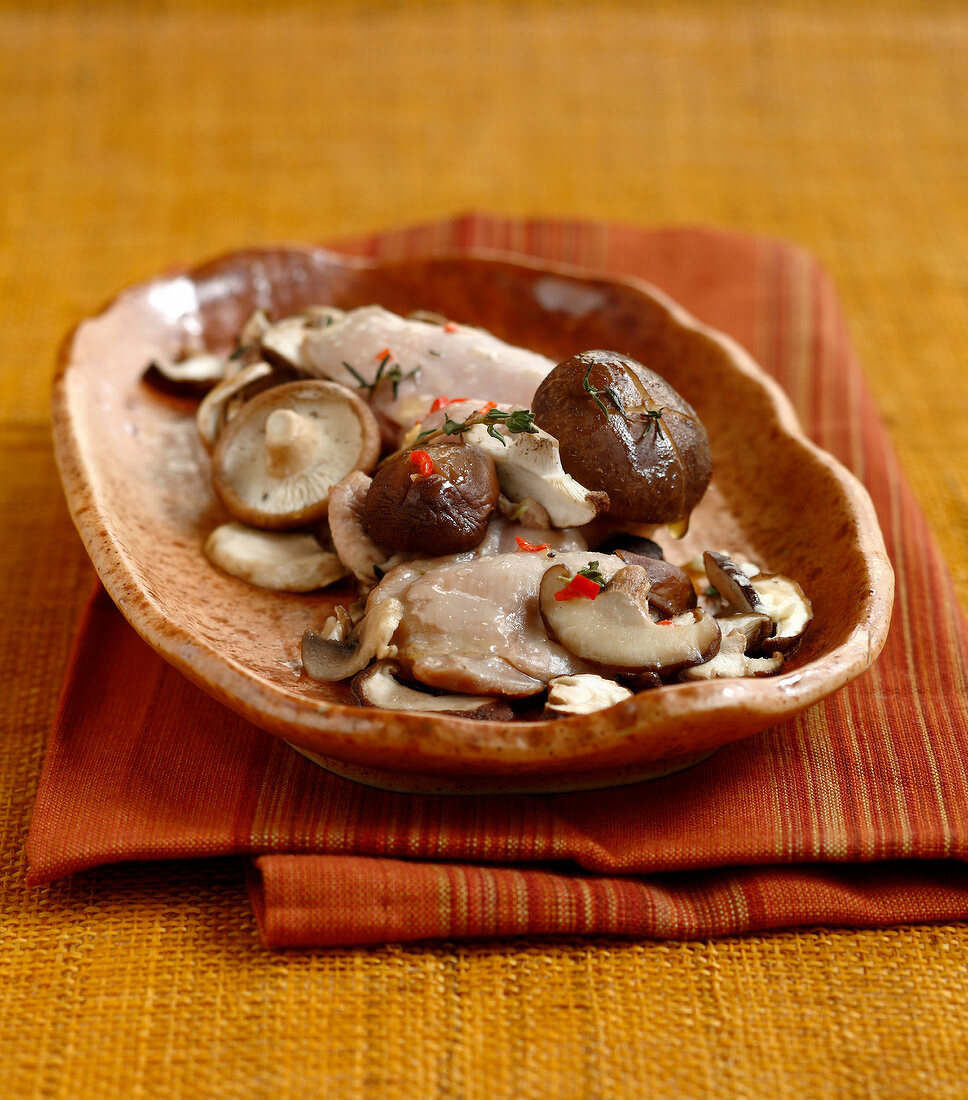 Guinea-fowl fillet with garlic shiitakes and button mushrooms