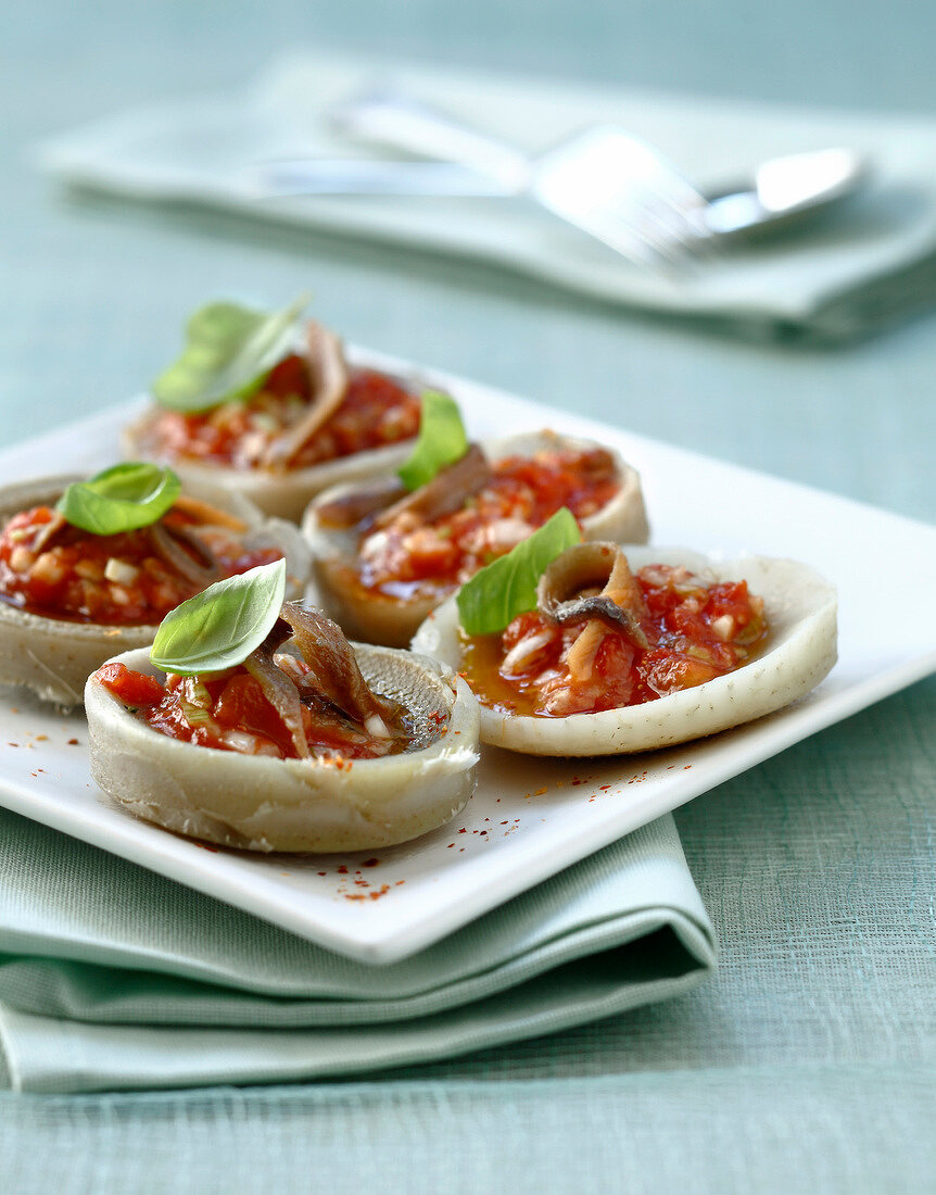 Steamed artichoke bases with tomatoes and anchovies