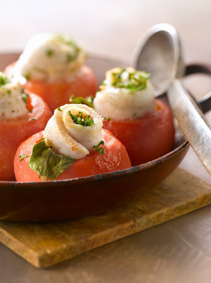 Tomatoes topped with rolled sole fillets