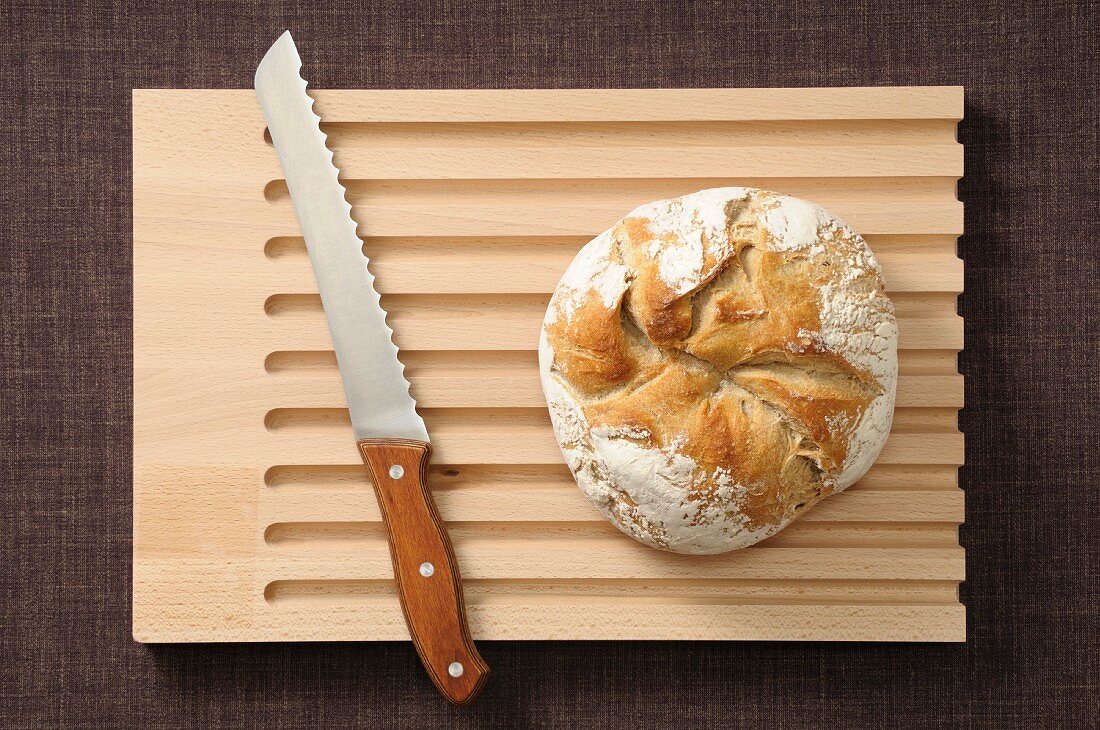 Round loaf of bread on a chopping board