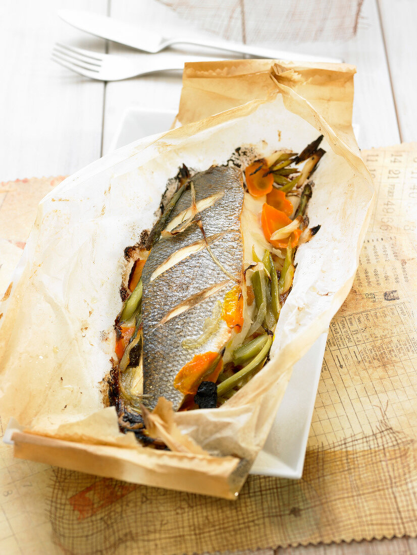 Bass with vegetables cooked in wax paper