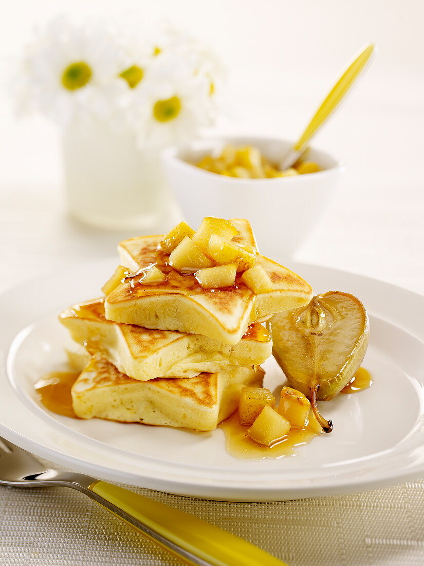 Star-shaped pancakes with diced pears and maple syrup