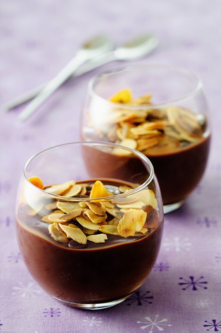 Dark chocolate cream dessert topped with thinly sliced almonds