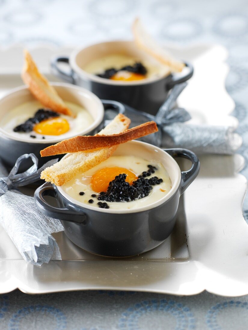 Small casserole dishes of coodled egg with caviar