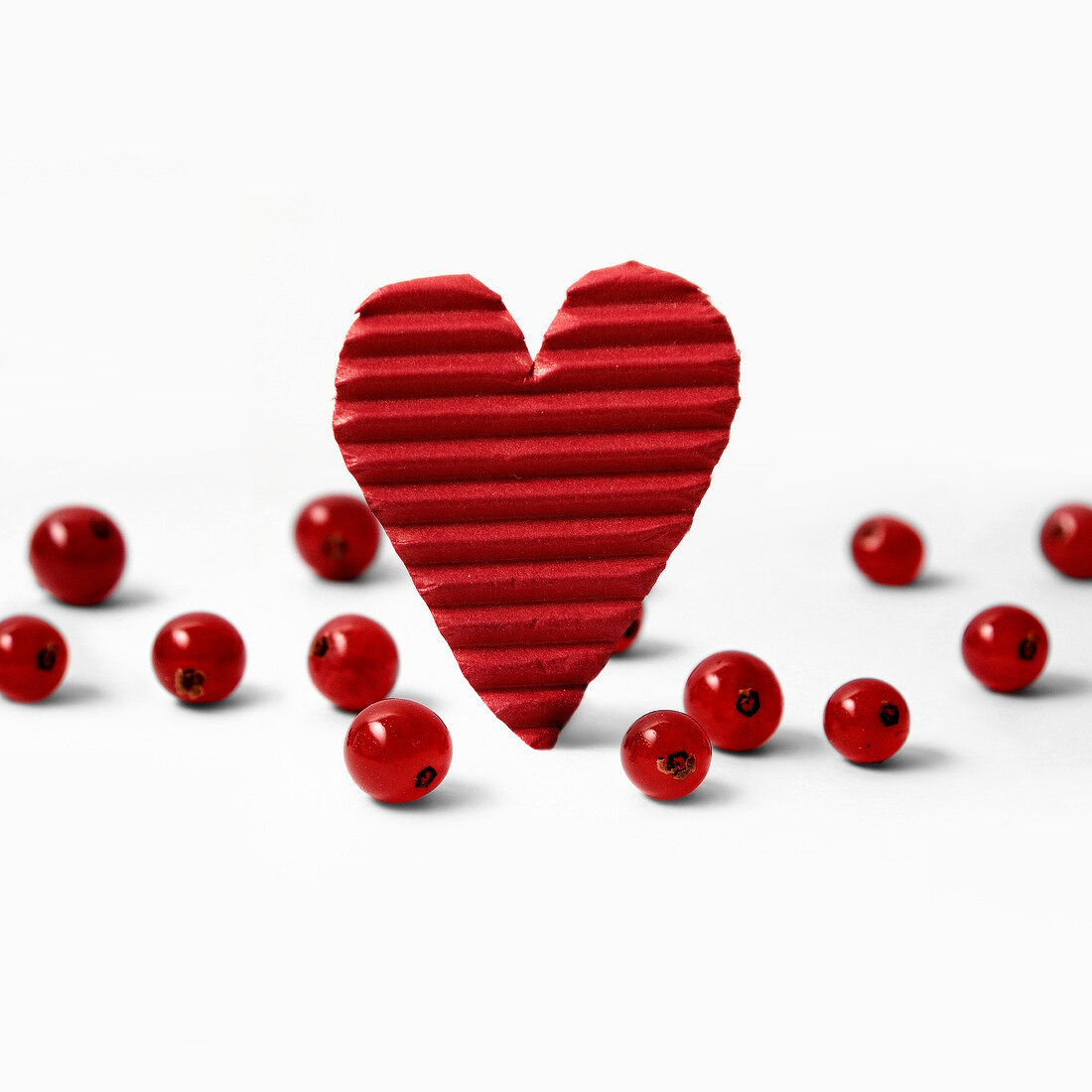 Red cardboard heart and redcurrants