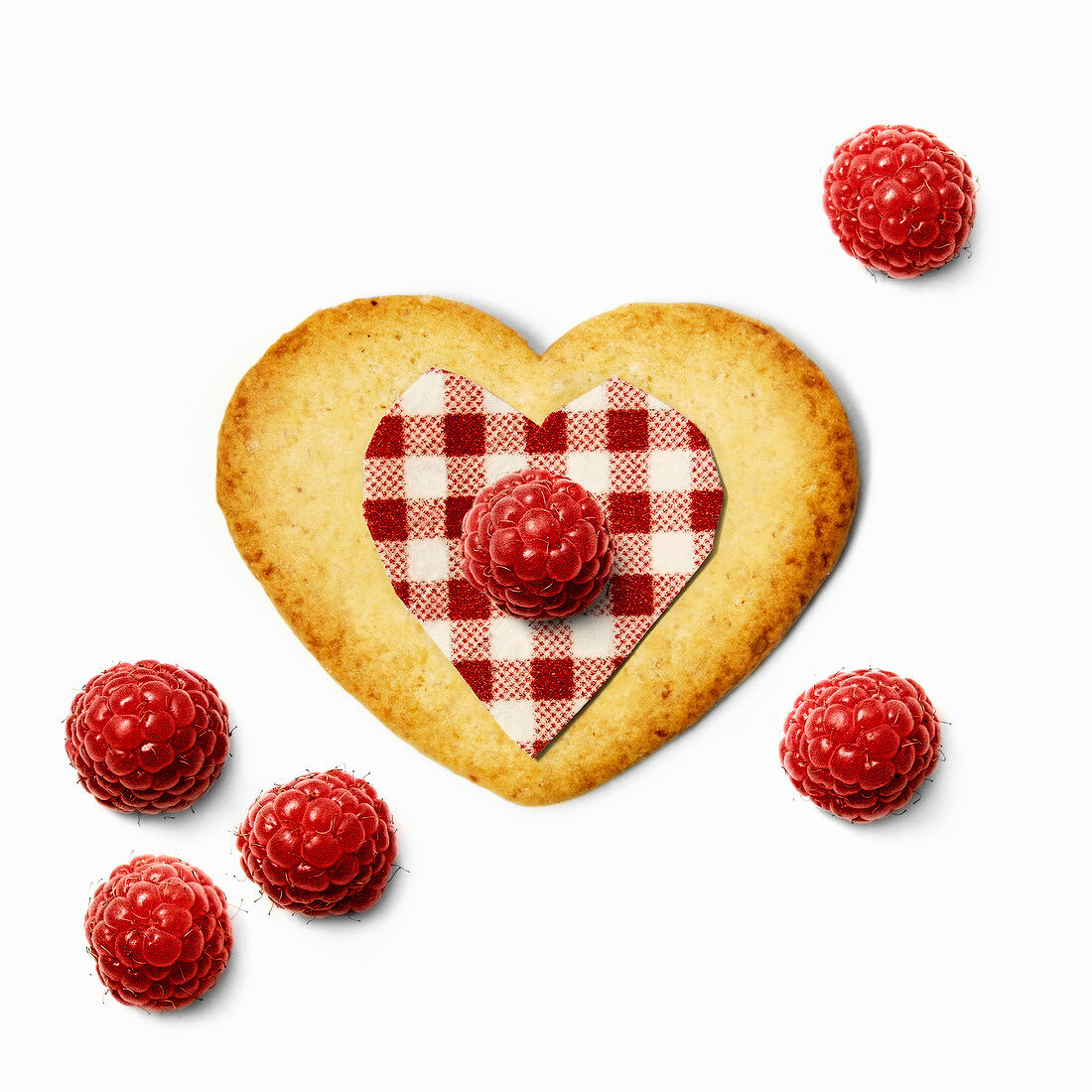 Heart-shaped cookie with raspberries