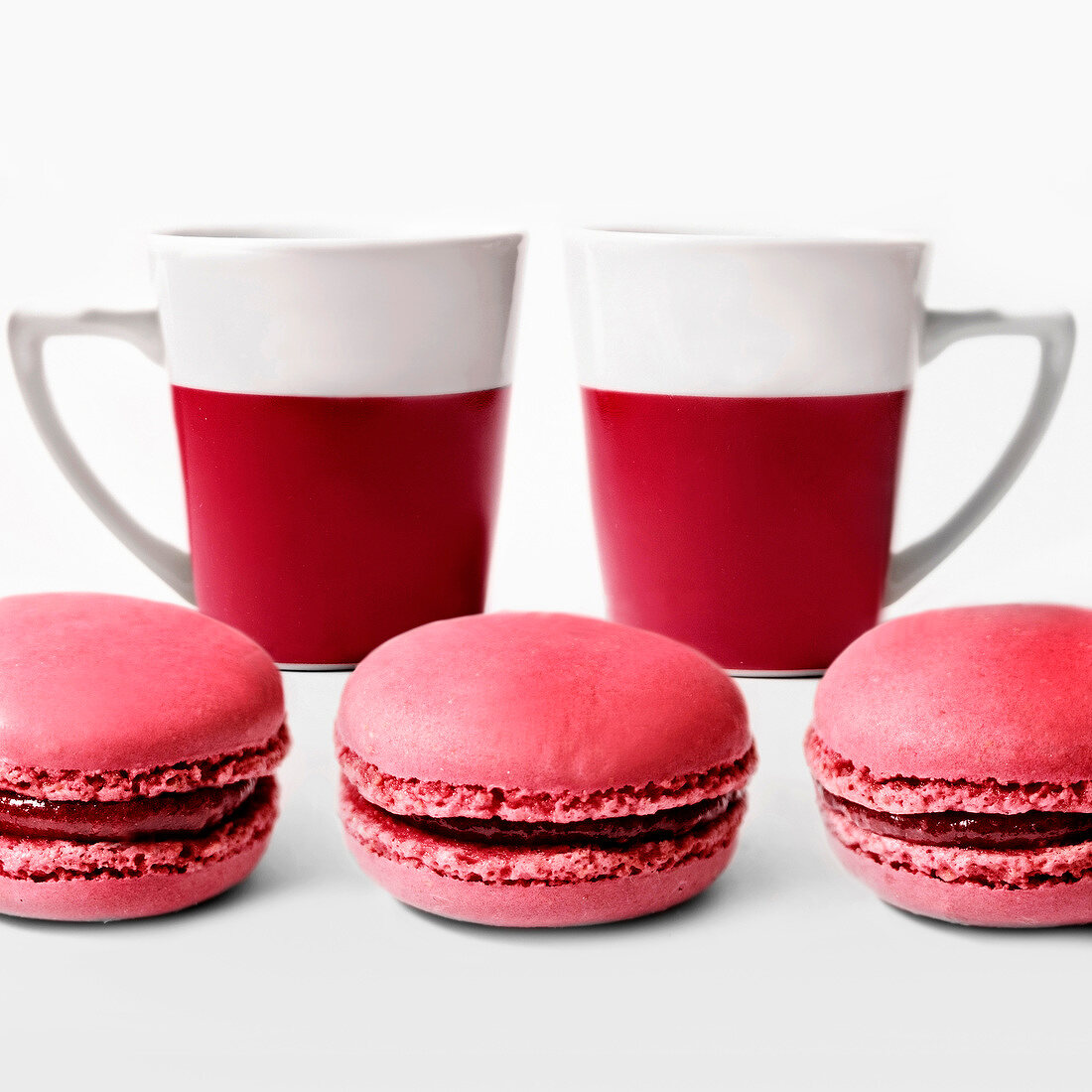Raspberry macaroons and two cups