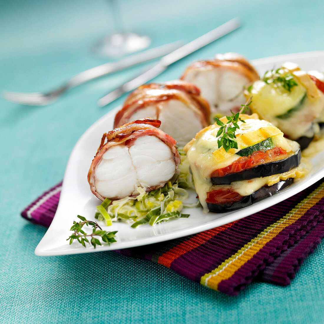 Monkfish wrapped in bacon with slowly cooked leeks,vegetable and Saint-Nectaire tian