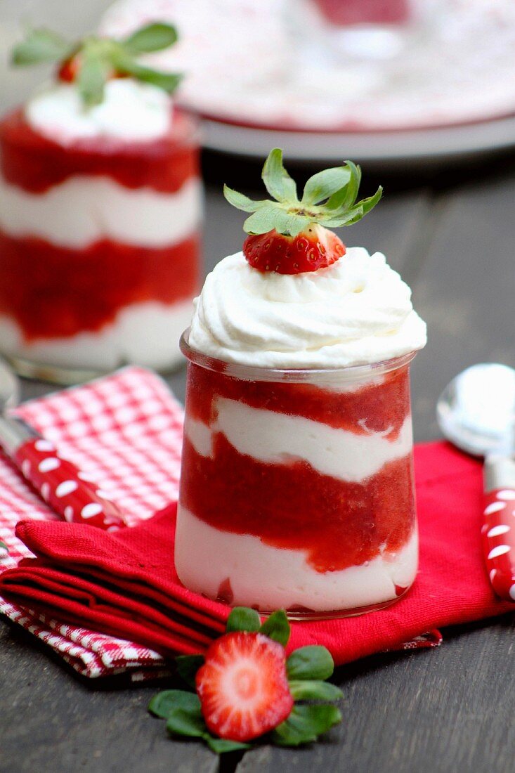 A layered dessert with strawberries and cream