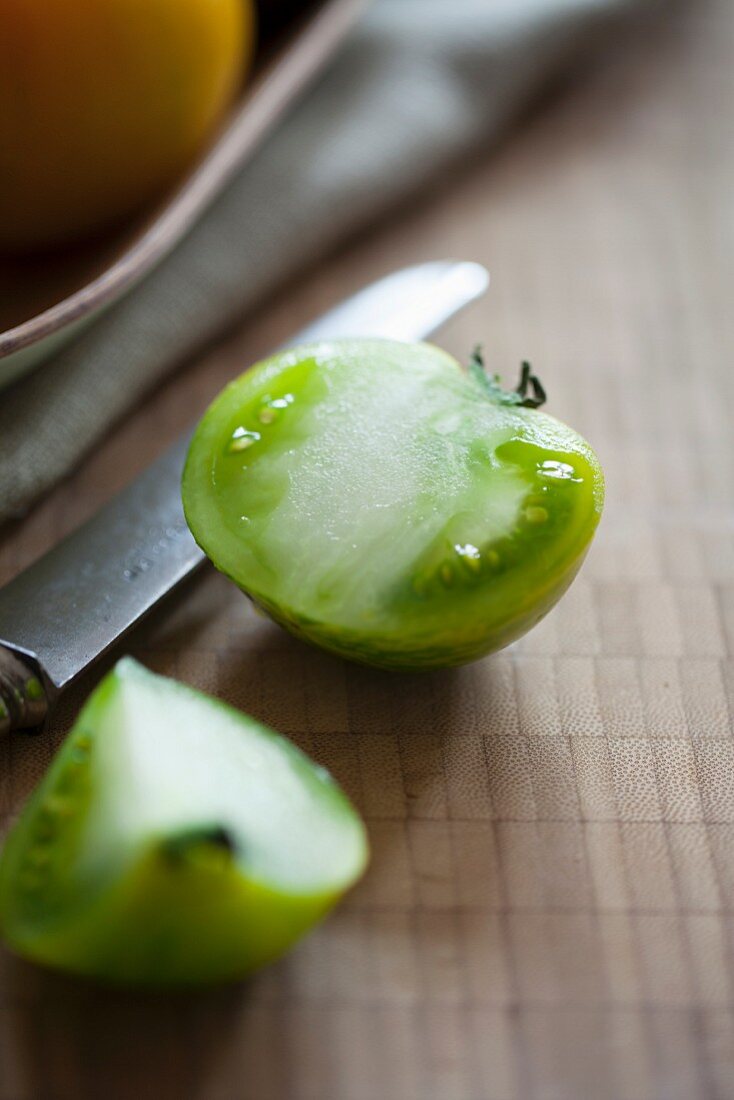 Green tomato cut in half