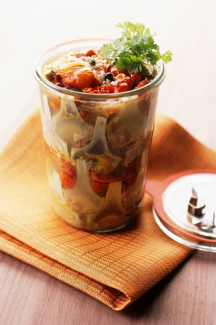 Jar of artichokes with sun-dried cherry tomatoes