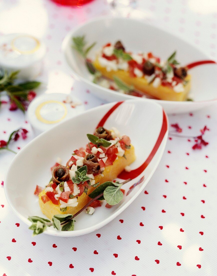 Polenta with tomatoes,mozzarella,capers and anchovies