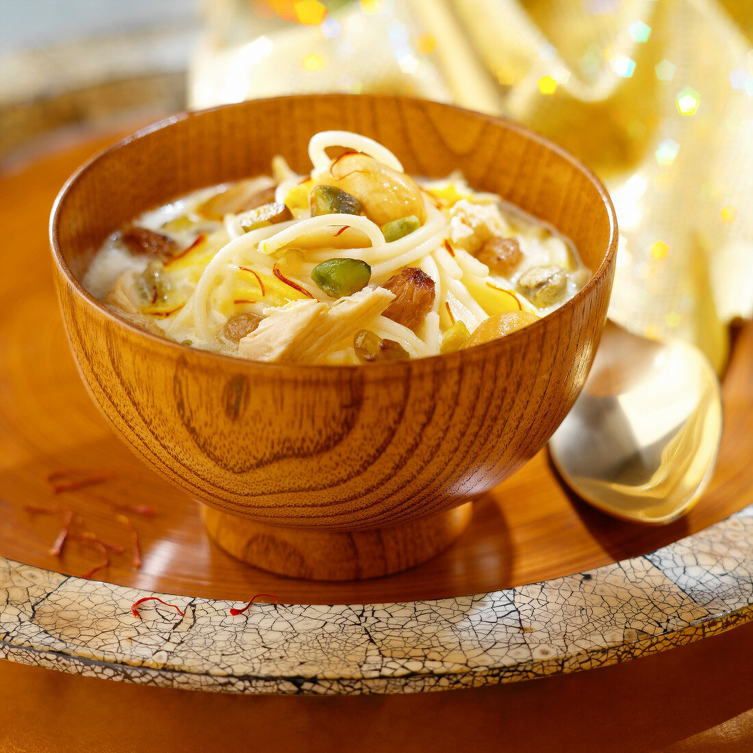 Noodles with creamy chicken, saffron, raisins, cashews and pistachios